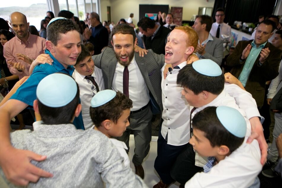 Rabbi dancing with Bar Mitzvah boys at a celebration