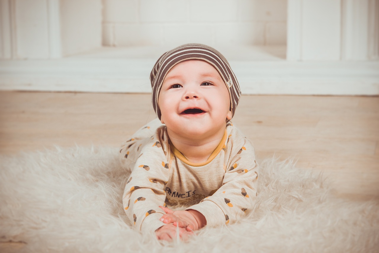 Smiling baby lying on a soft rug