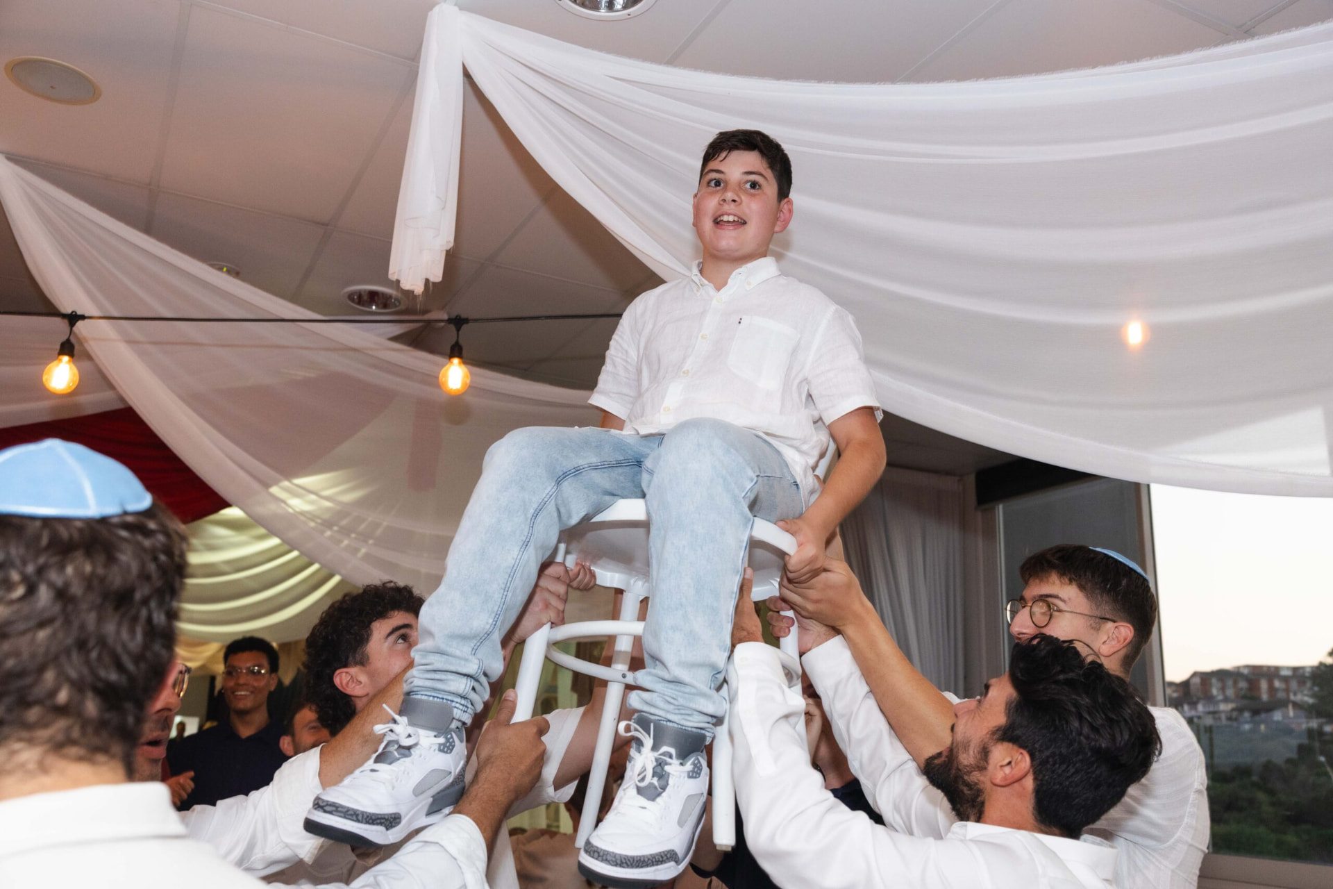 A child lifted on a chair during a celebration