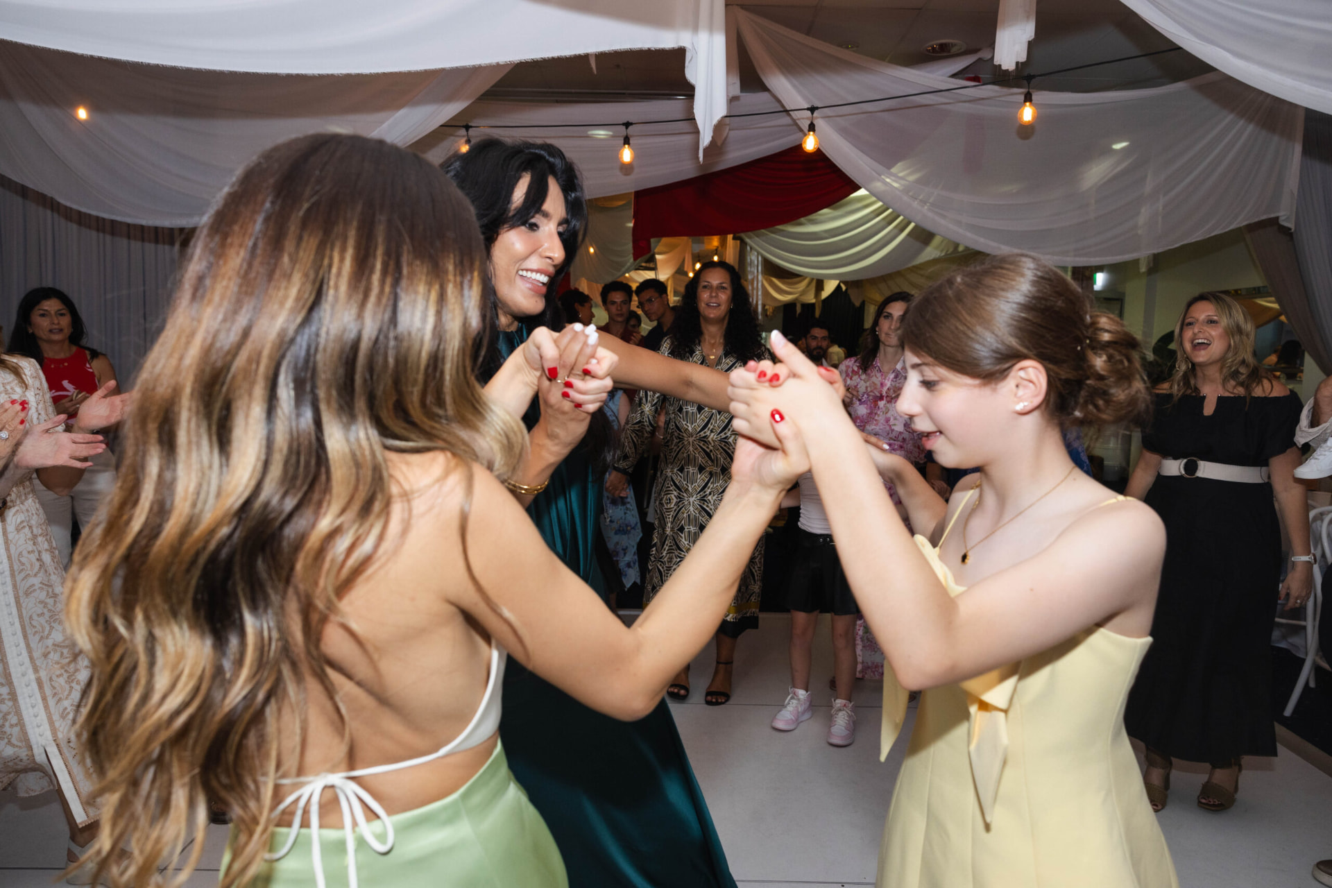 Guests holding hands and dancing at a Bat Mitzvah celebration
